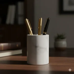 Minimalist white marble pen holder showcasing several elegant pens as part of the desired upscale desk accessories aesthetic.