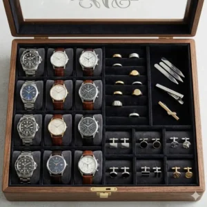 Close-up of the designated watch slots and ring rolls inside a mens engraved jewelry box.