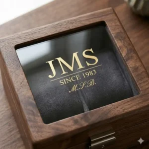A handcrafted walnut wood personalised mens jewellery box with a glass lid and velvet lining.