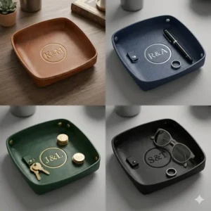 A personalized leather nightstand organizer holding a smartphone, keys, and sunglasses to demonstrate daily utility.
